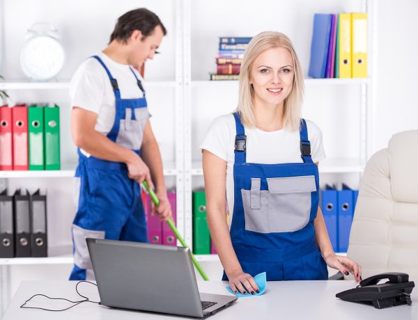 Young couple professional cleaners are cleaning the office.